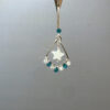 Handcrafted teal star earring close-up