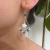 Teal star drop earring worn view