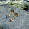 Gold cloud pearl and amethyst tassel earrings in natural light