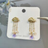 Gold cloud amethyst and pearl tassel earrings displayed as a pair