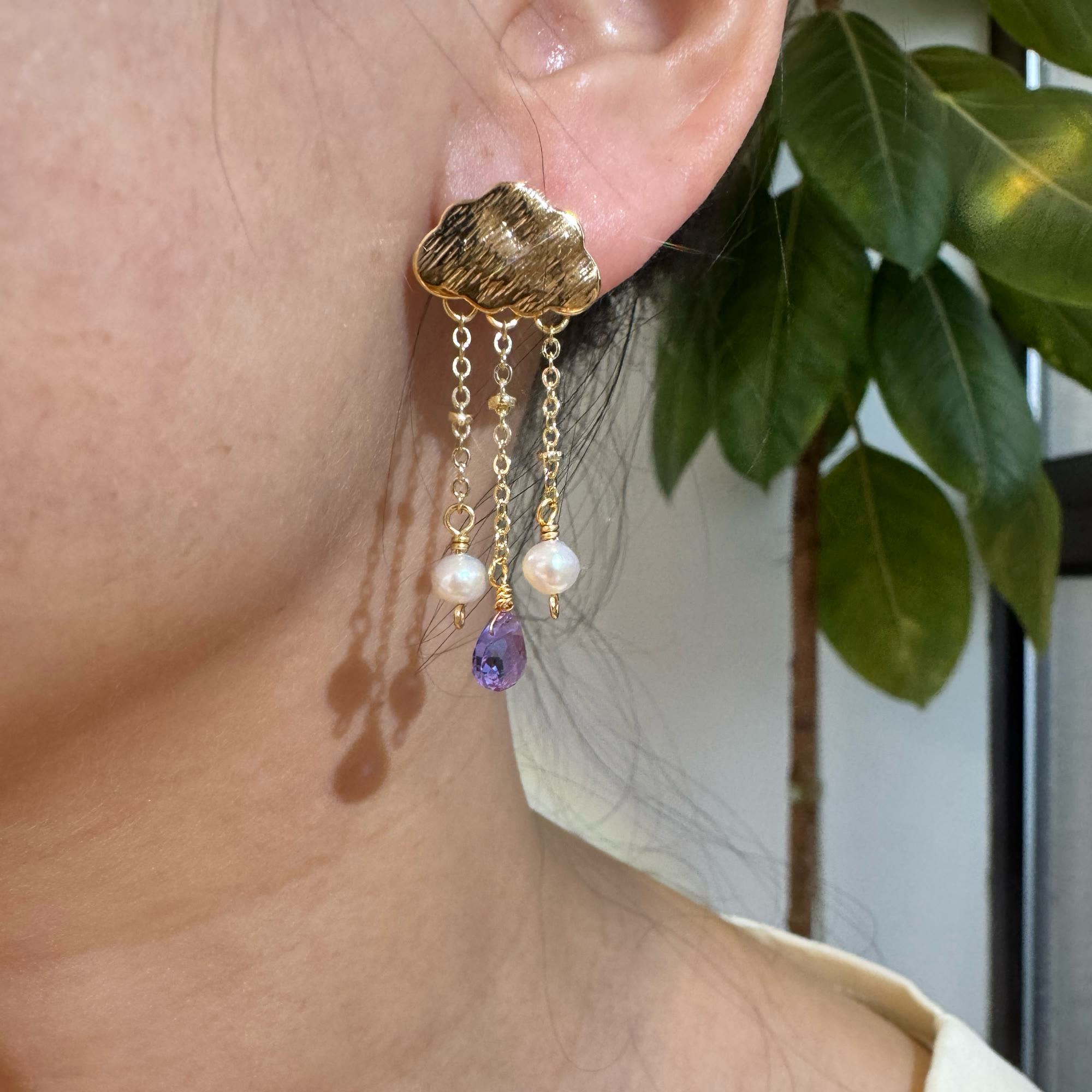 Gold cloud amethyst and pearl tassel earring worn on ear