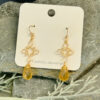 Pair of gold filigree earrings with faceted golden teardrop stones