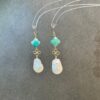 Teal clover stone and baroque pearl drop earrings close-up