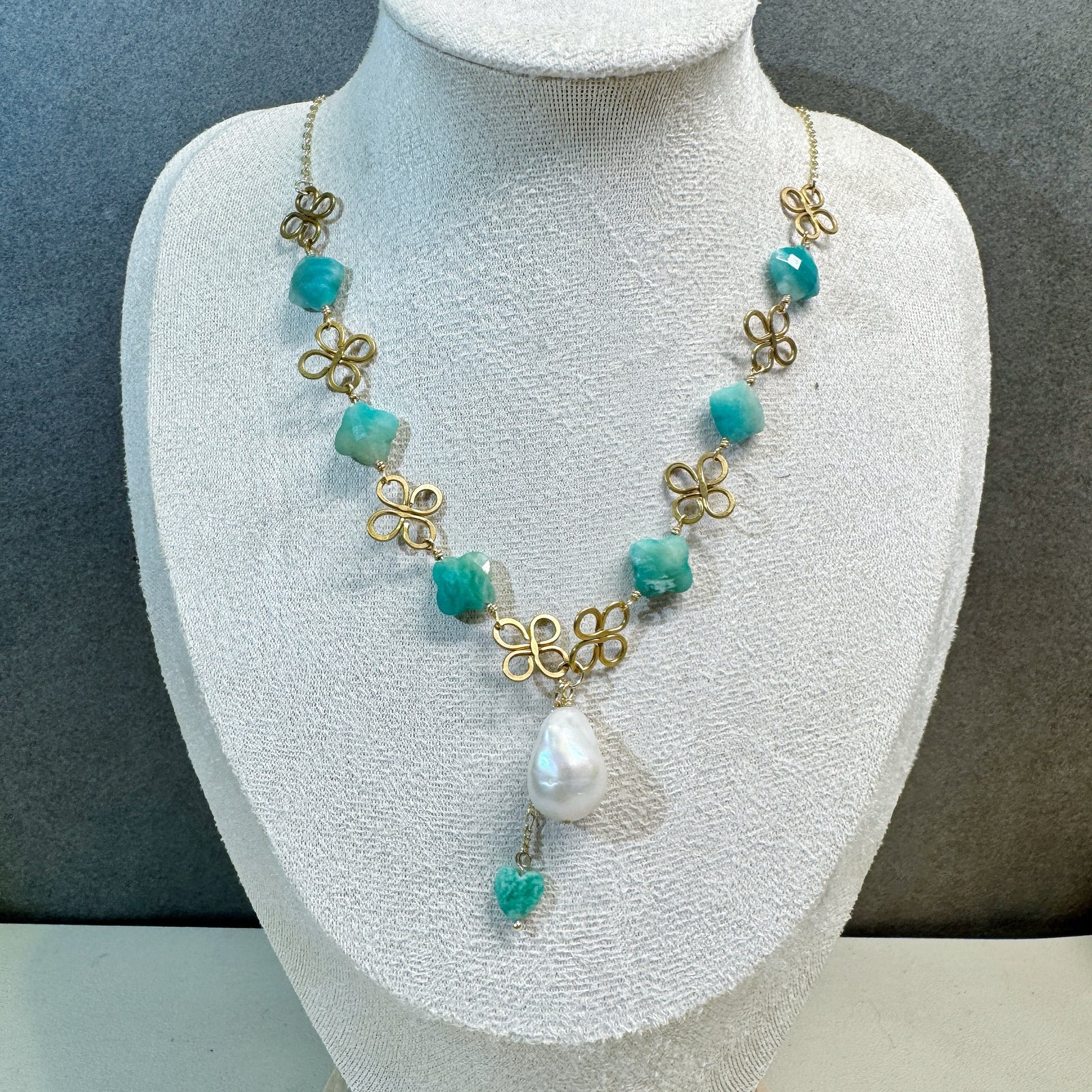 Baroque pearl clover necklace on jewelry display bust