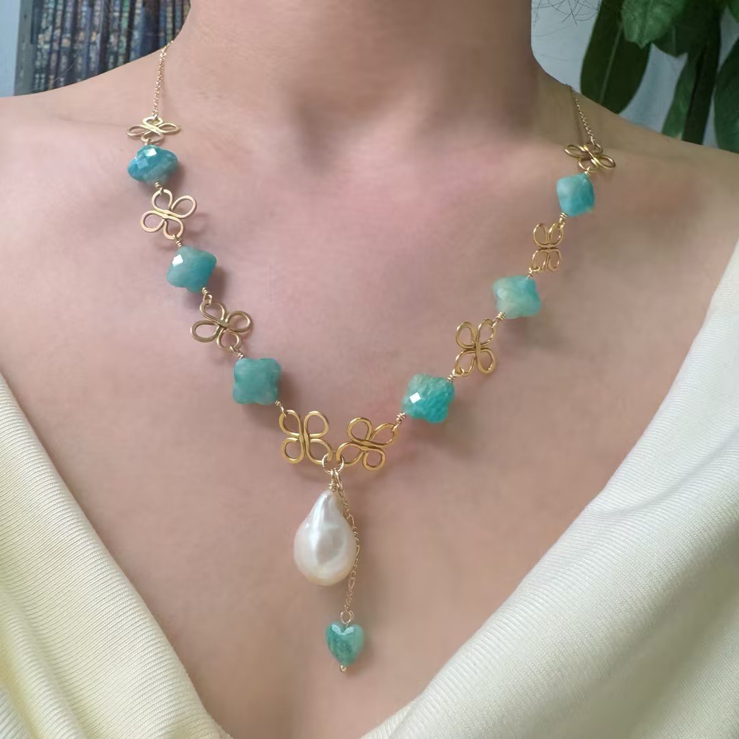 Gold clover baroque pearl necklace worn on model
